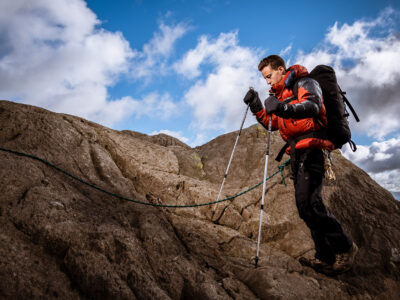 COMMERCIAL PHOTOGRAPHER - A photograph of a climbing model ascending in a down jacket
